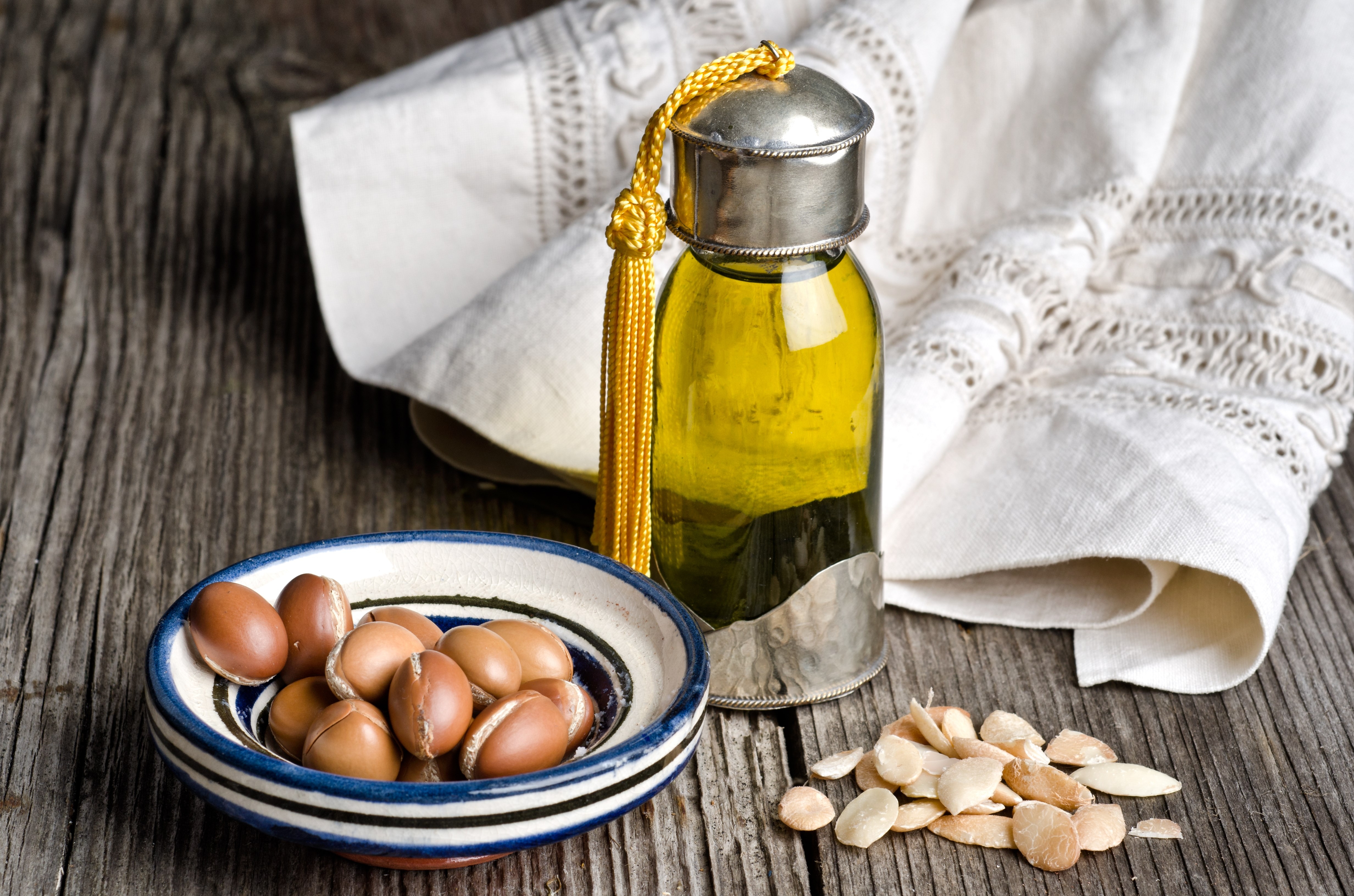 Bottle of argan oil and argan fruit. Argan oil is used for skincare products.