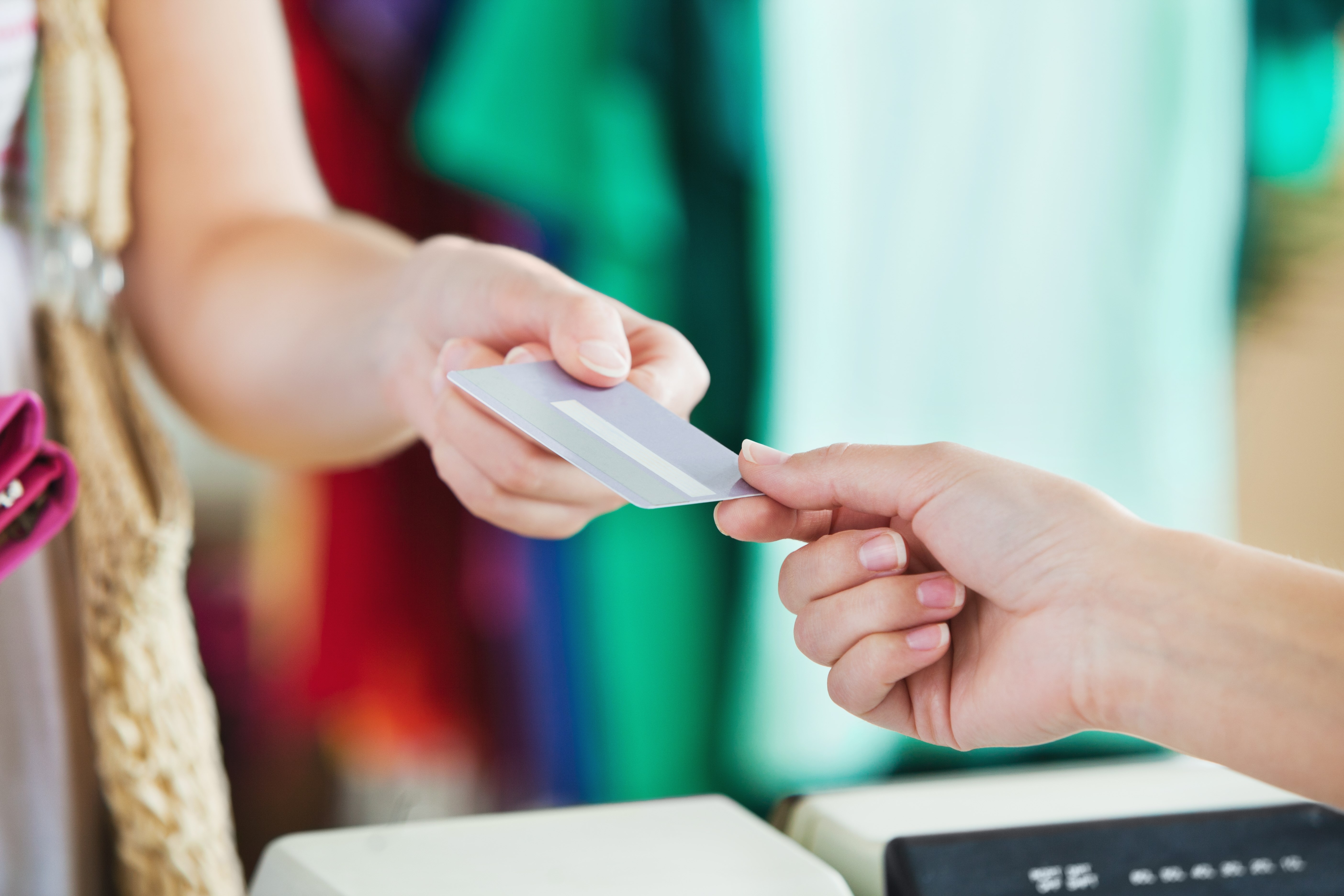 Close-up of a woman paying with her credit card in a shop