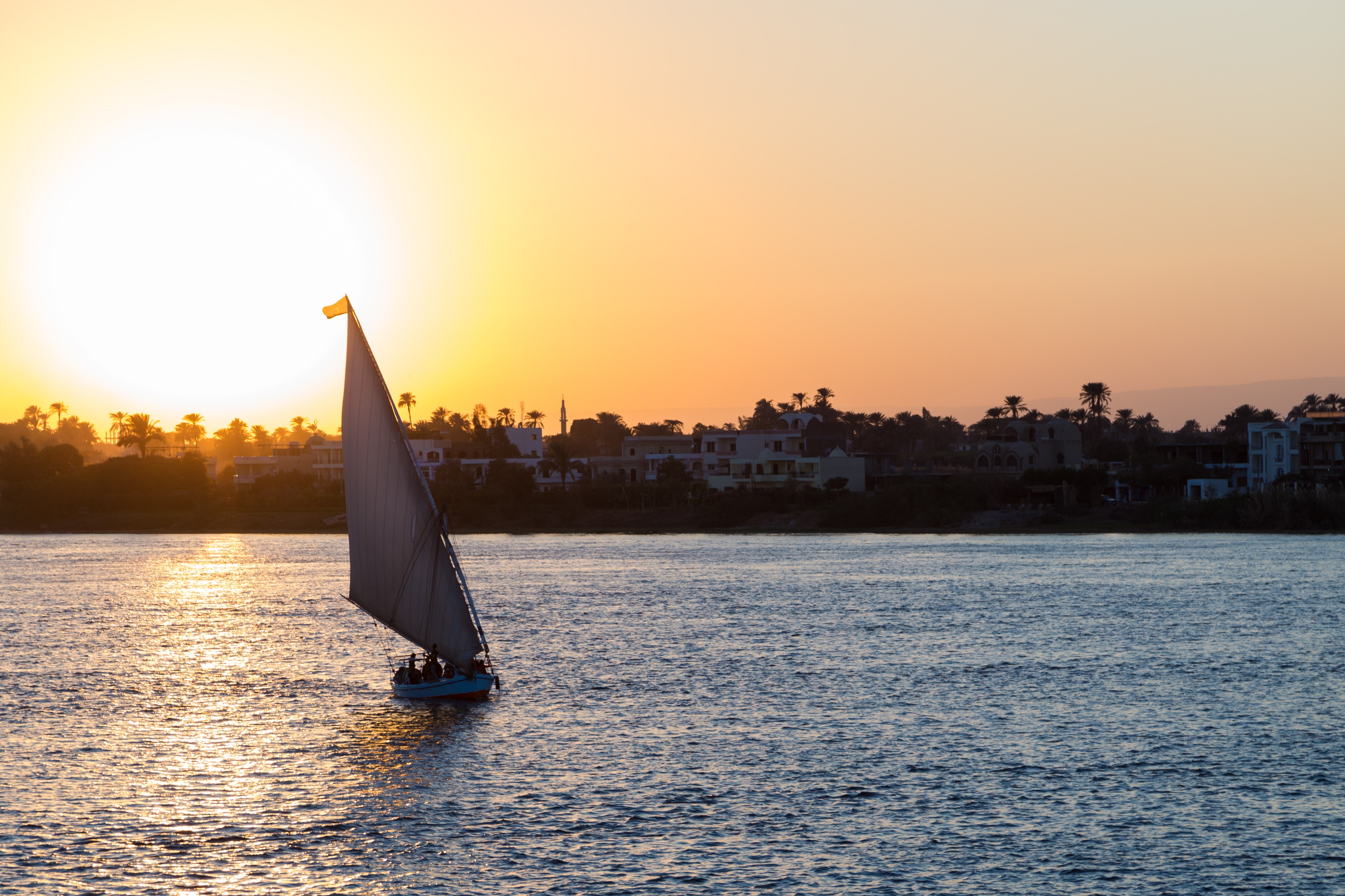 Tourist sailboat at Luxor waterfront during sunset. - Image