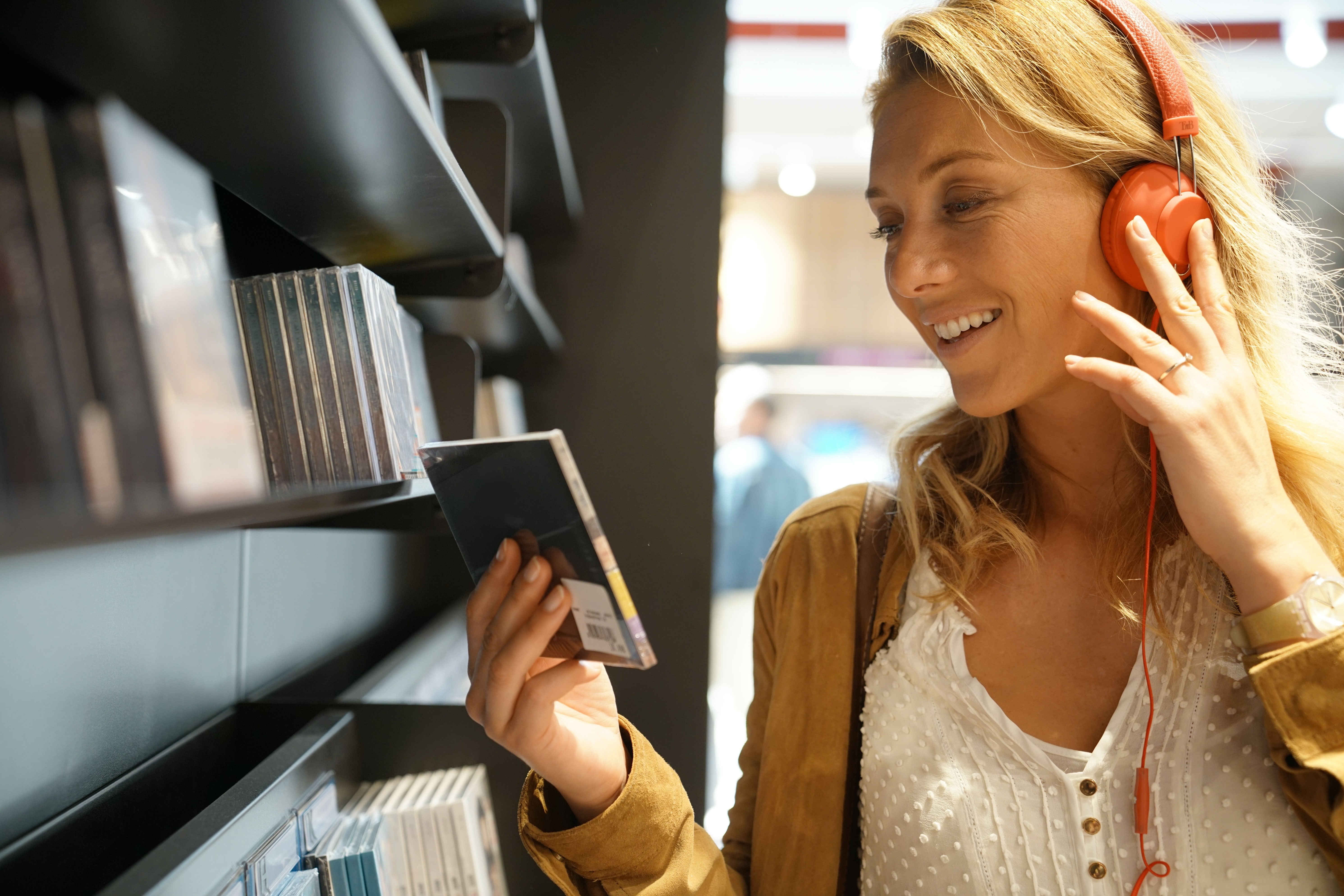 Woman in multimedia store testing new music discs