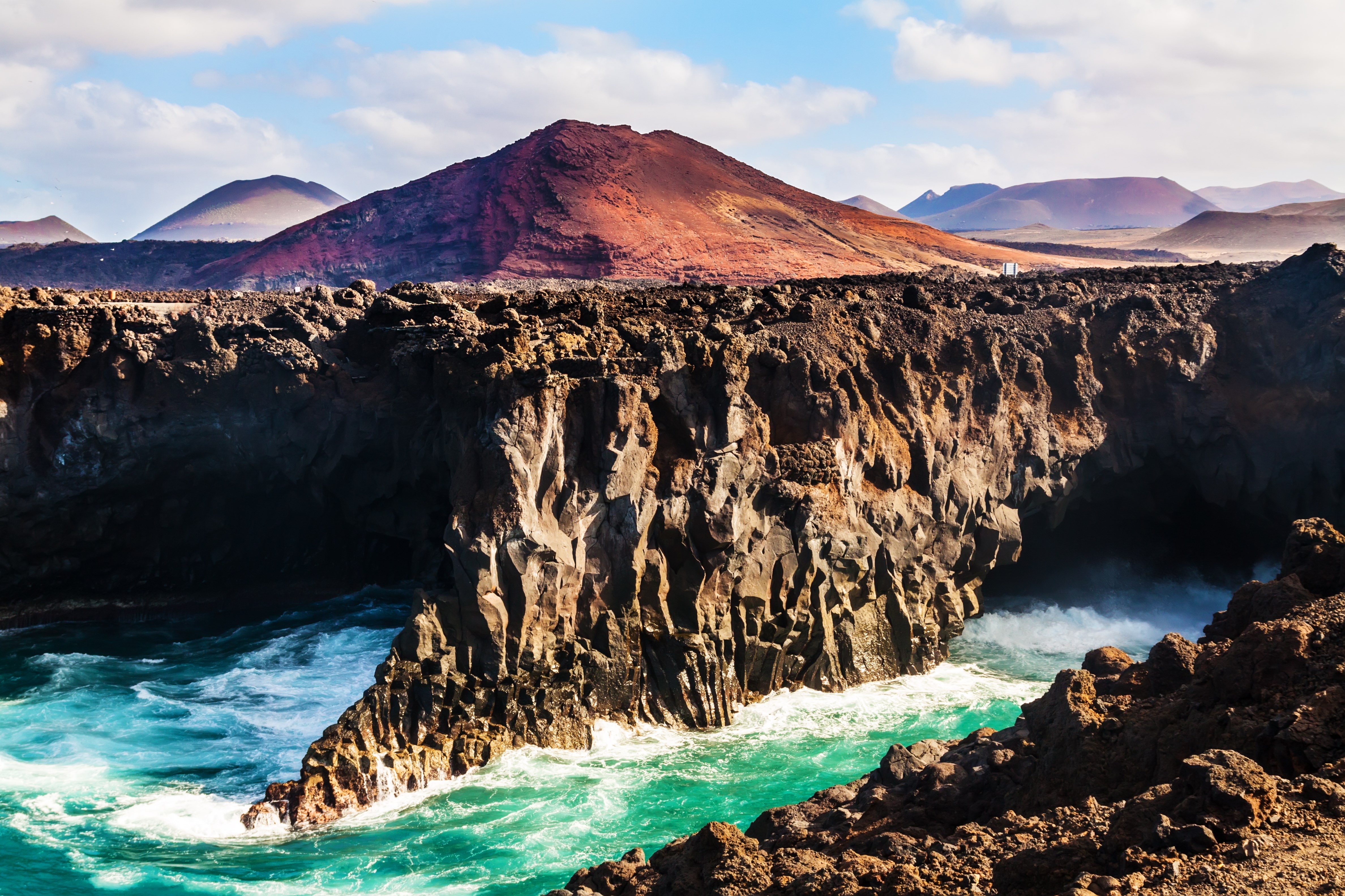 Los Hervideros, coastline in Lanzarote with waves and volcano