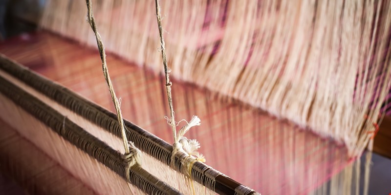 Vintage manual weaving loom with unfinished textile work