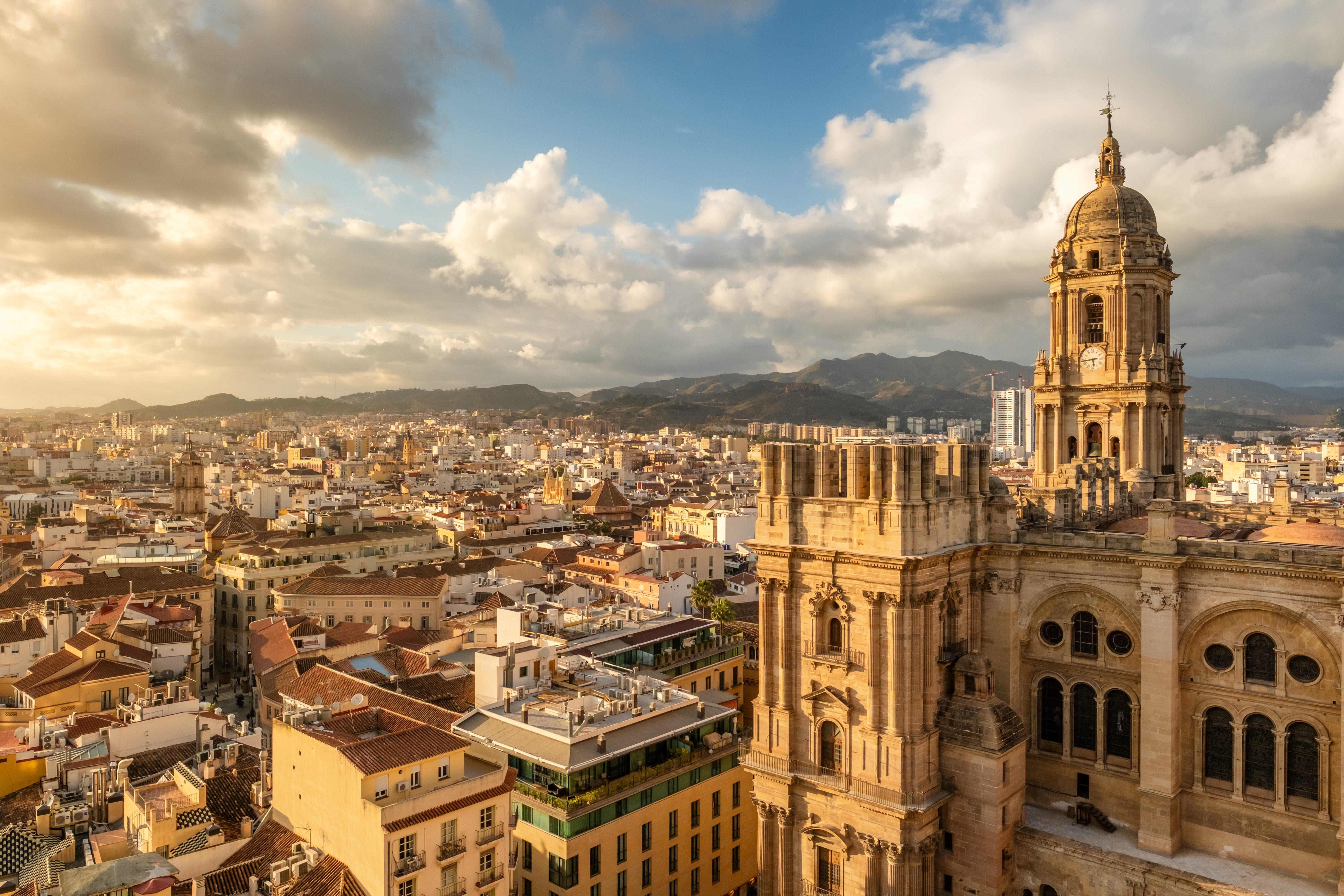 Malaga cityscape with beautiful Cathedral of the incarnation at sunset, Spain. Malaga old town, Cathedral and skyline of the city.