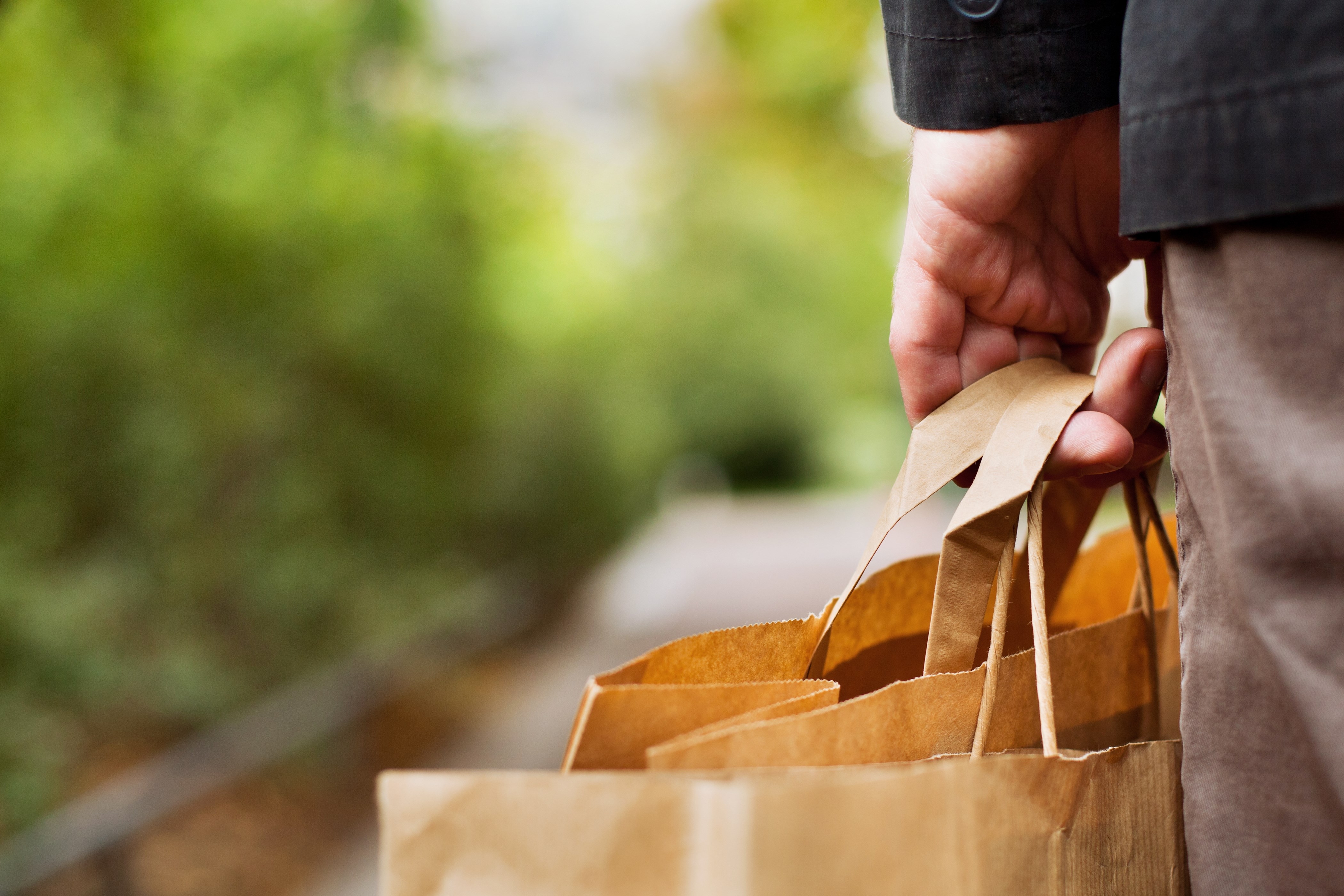 man carrying shopping bags