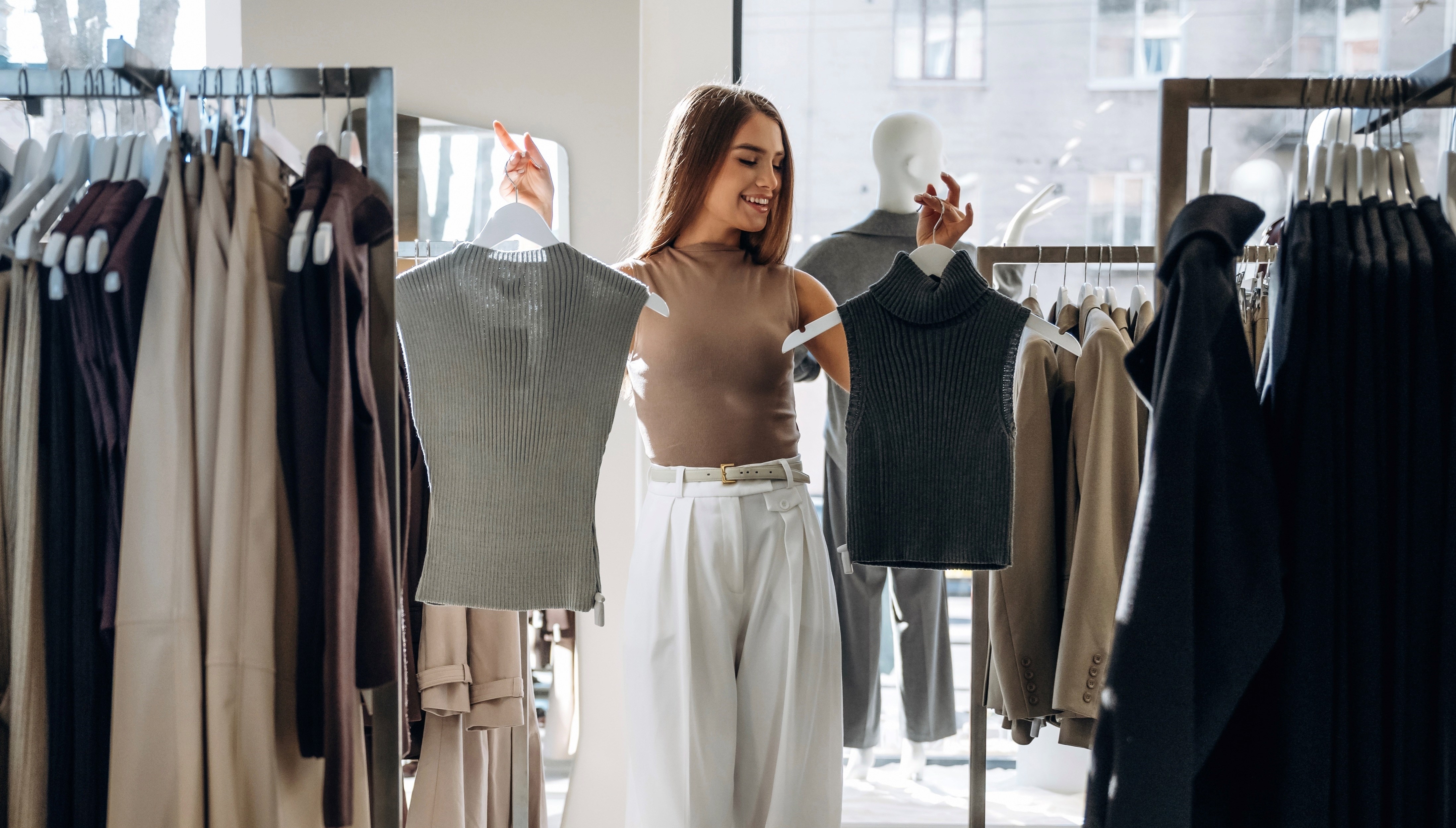 Making the choice. Woman chooses clothes in retail store.