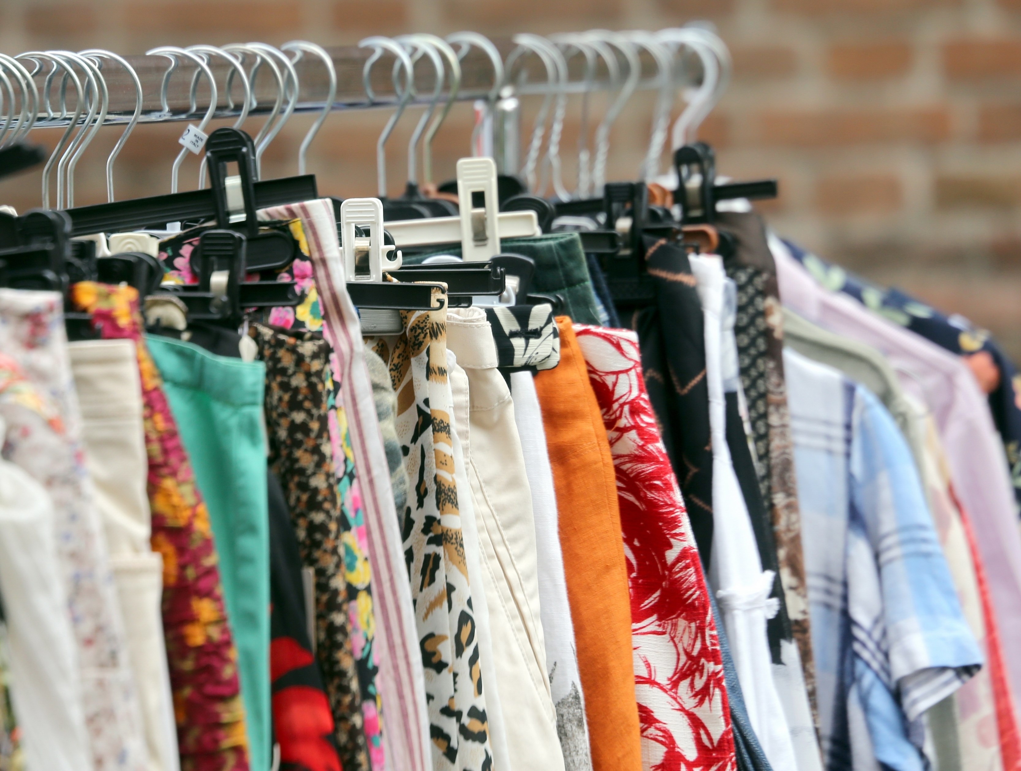 vintage clothes hanging in the flea market of used things