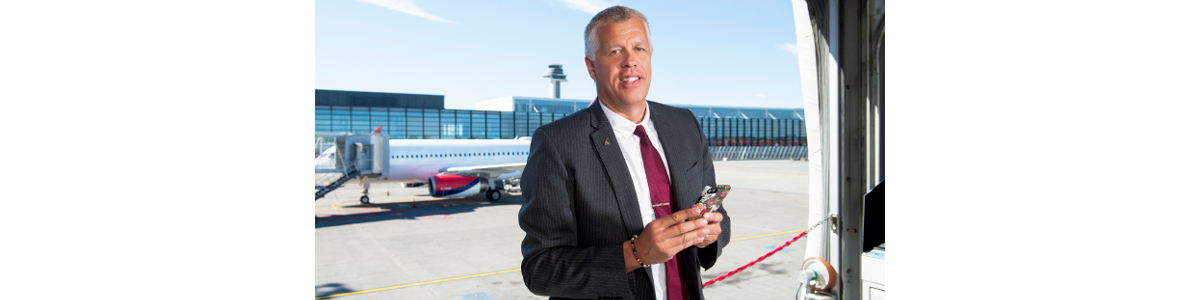 a man in a suit with Arlanda flight tower in the background a man in a suit with Arlanda flight tower in the background