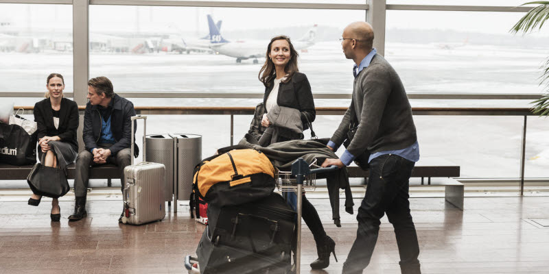 Two travelers with a luggage carrier Two travelers with a luggage carrier