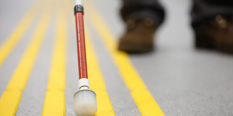 Blind pedestrian walking and detecting markings on tactile paving with textured ground surface indicators for blind and visually impaired Blind pedestrian walking and detecting markings on tactile paving with textured ground surface indicators for blind and visually impaired
