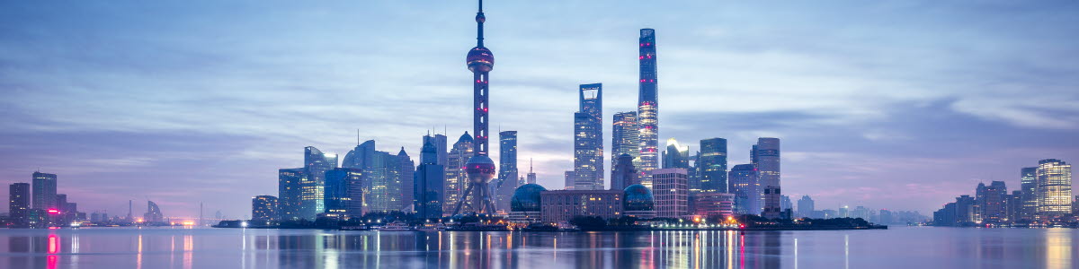 A skyline of the city of Shanghai with blue sky and blue water A skyline of the city of Shanghai with blue sky and blue water