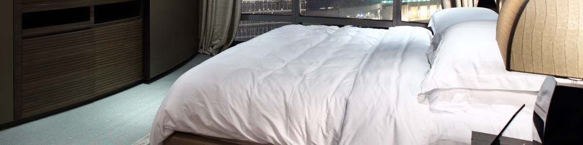 Hotel room with a bed and a view over a city Hotel room with a bed and a view over a city