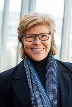 A photo of Katrin Bäckman, a blond woman with glasses and a blue scarf A photo of Katrin Bäckman, a blond woman with glasses and a blue scarf