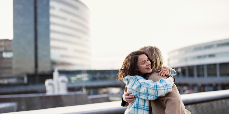 Two persons hug outside the terminal. Two persons hug outside the terminal.