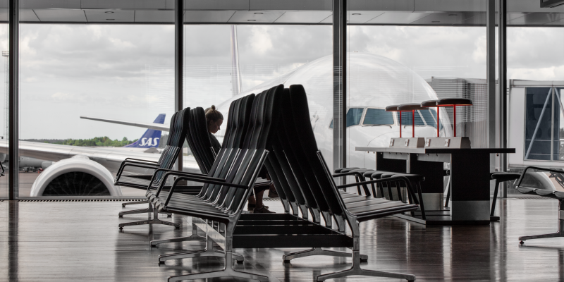 Seats at windows at Arlanda terminal 5 with an aircraft outside Seats at windows at Arlanda terminal 5 with an aircraft outside