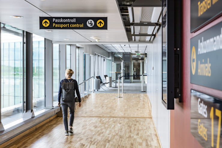 A travler walking towards the passport control A woman walking towards the passport control