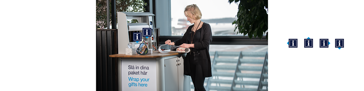 a woman wrapping gifts at a table at Arlanda a woman wrapping gifts at a table at Arlanda