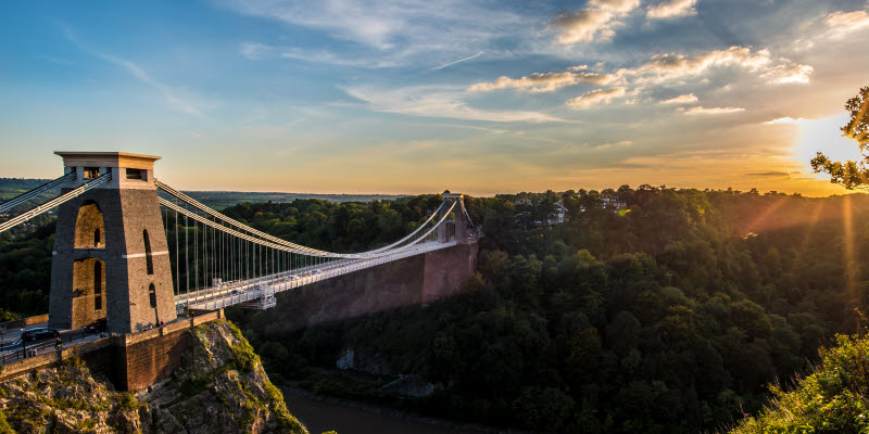 Clifton Suspension Bridge, Bristol, UK with sunset and sunbeams Clifton Suspension Bridge, Bristol, UK with sunset and sunbeams