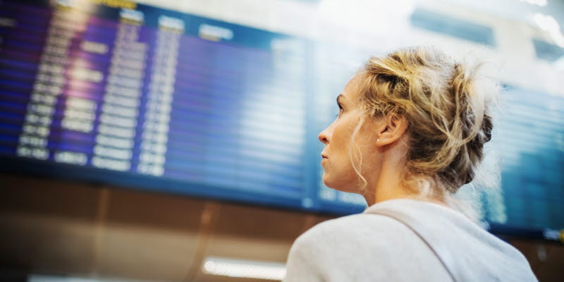 A person looking at board with arrivals or departures at Arlanda A person looking at board with arrivals or departures at Arlanda