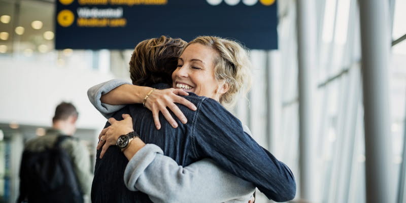 women is hugging a passenger at the airport women is hugging a passenger at the airport