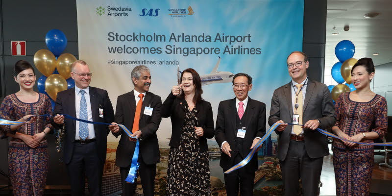 People holding and cutting a ribbon People holding and cutting a ribbon