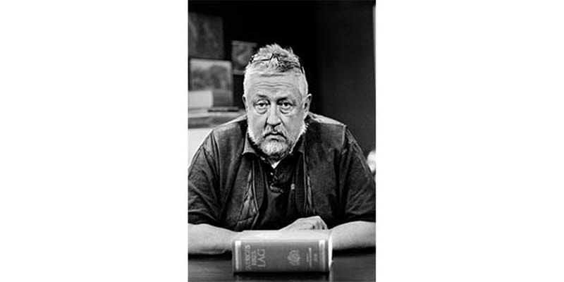 A photo of Leif GW Persson with the Swedish law book in front of him A photo of Leif GW Persson with the Swedish law book in front of him