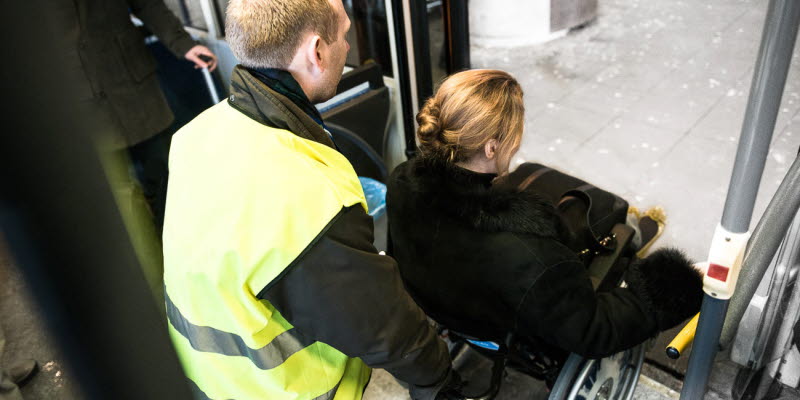 A person with reduced mobility gets assistance in a wheel chair A person with reduced mobility gets assistance in a wheel chair
