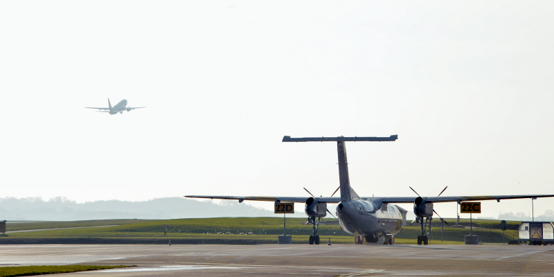 An aircraft on the ground and one in the air An aircraft on the ground and one in the air