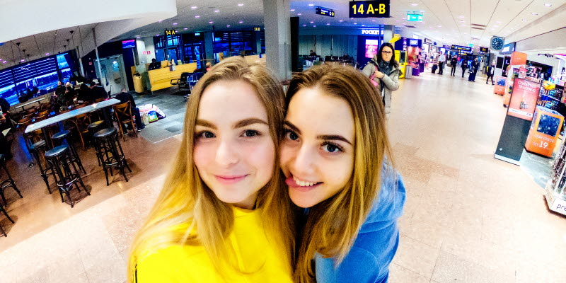 Two girls taking a selfiek in the terminal§ Two girls taking a selfiek in the terminal§