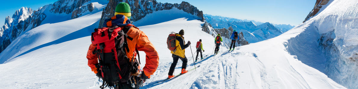 A group of skiers start the descent of Valle Blanche, the most famous offpist run in the Alps, Valle Blanche descent links Italy and France through the Mont Blanc Massif. Chamonix, France, Europe. A group of skiers start the descent of Valle Blanche, the most famous offpist run in the Alps, Valle Blanche descent links Italy and France through the Mont Blanc Massif. Chamonix, France, Europe.