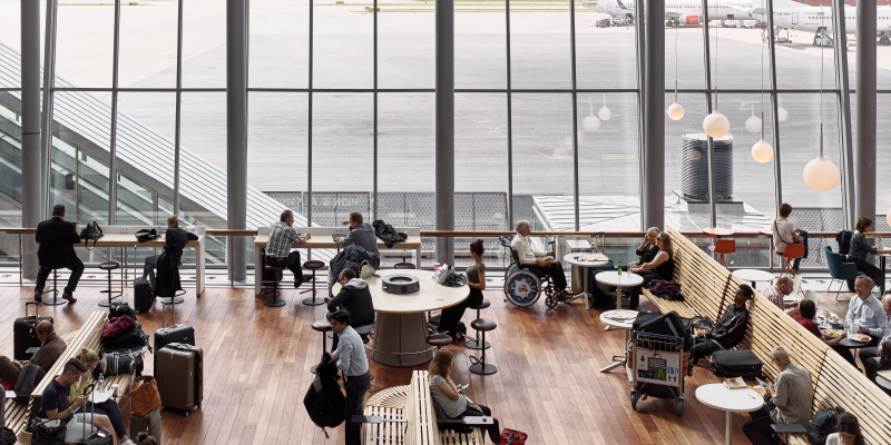 People in SkyCity Arlanda at large windows with airplanes outside People in SkyCity Arlanda at large windows with airplanes outside